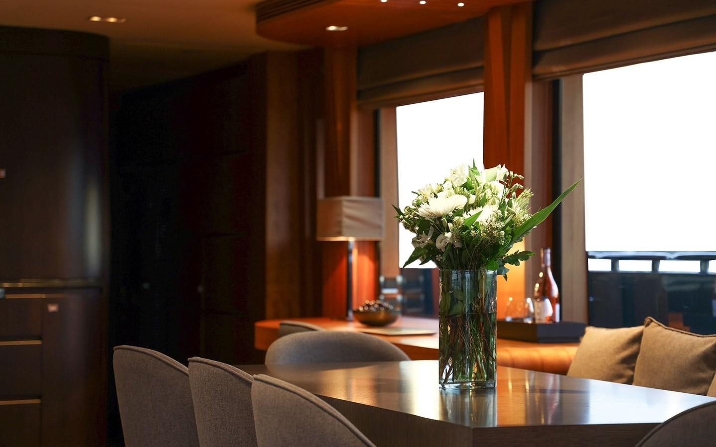a vase of white flowers on a table aboard FUNKY CHOICE Yacht for Sale