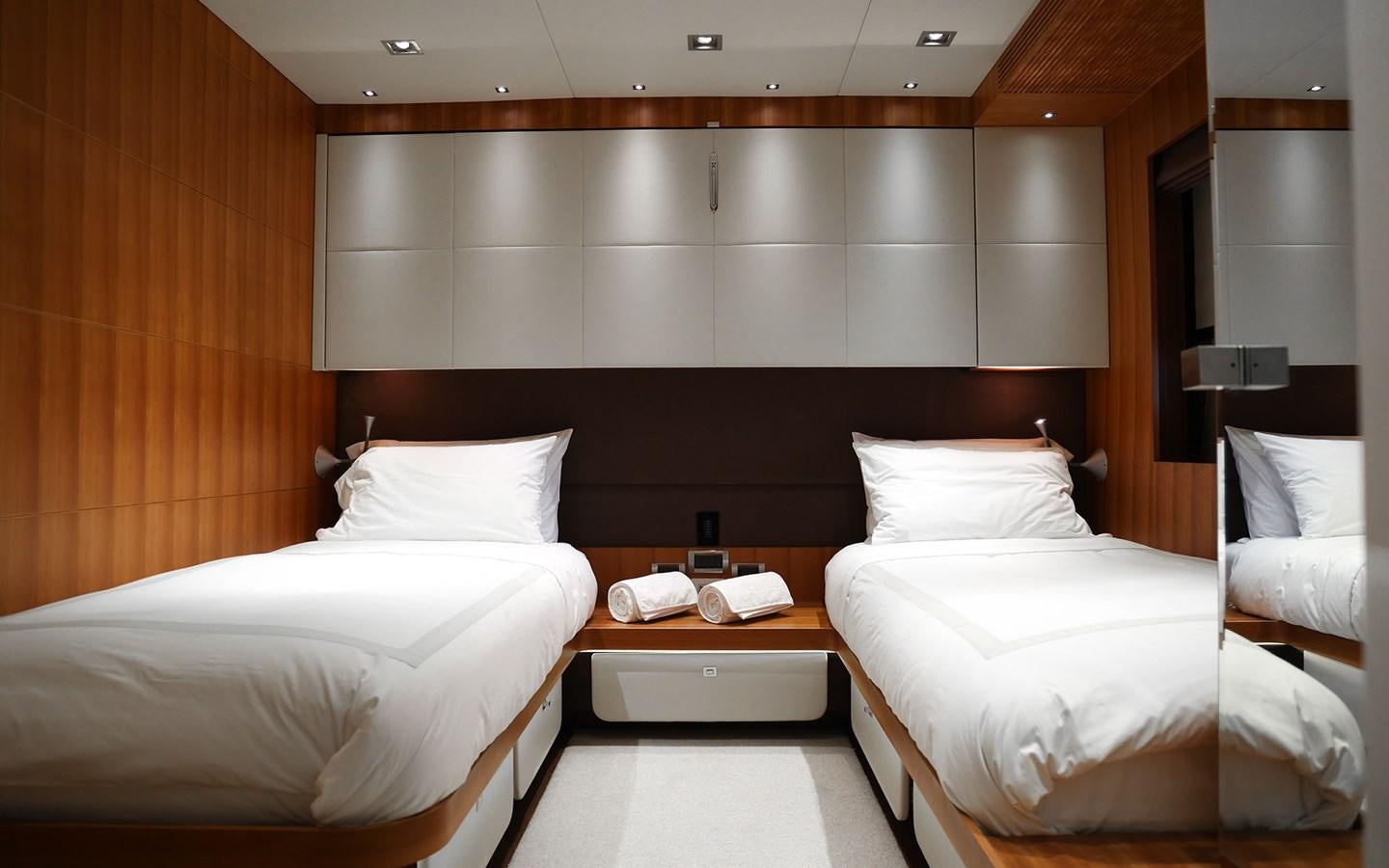 a room with beds and a desk aboard FUNKY CHOICE Yacht for Sale