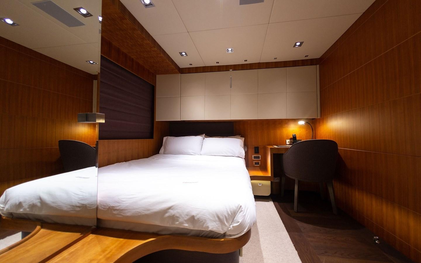 a room with a bed and a chair aboard FUNKY CHOICE Yacht for Sale