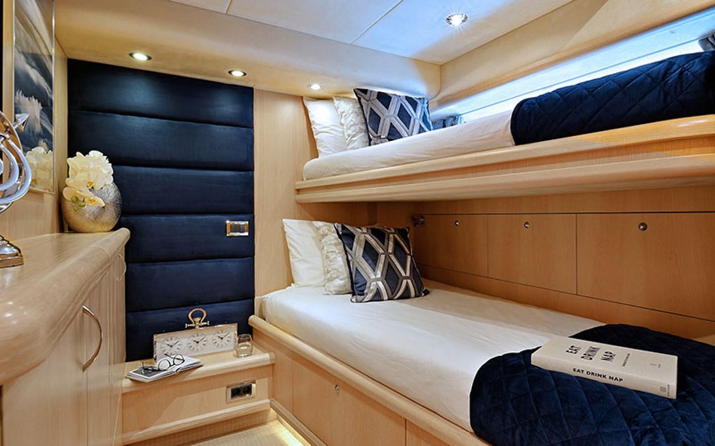 a bed with a blue sheet aboard EXCELERATE Z Yacht for Sale