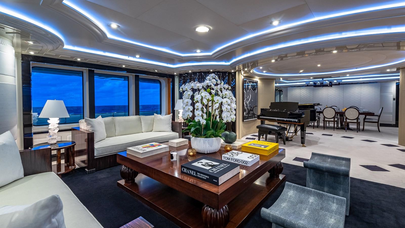a living room with a piano and a piano aboard MARGUERITE Yacht for Charter