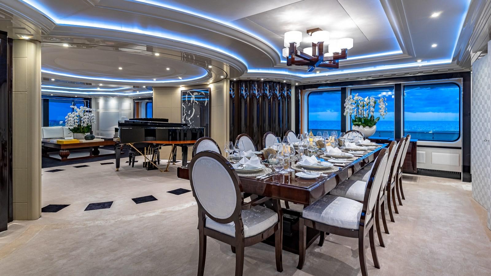 a room with tables and chairs aboard MARGUERITE Yacht for Charter