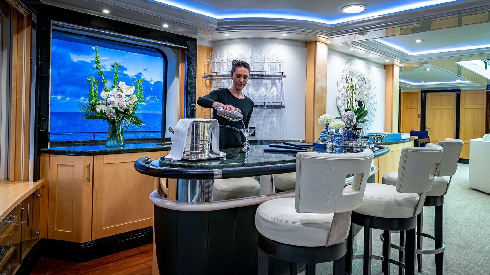 a person sitting at a table in a restaurant aboard MARGUERITE Yacht for Charter