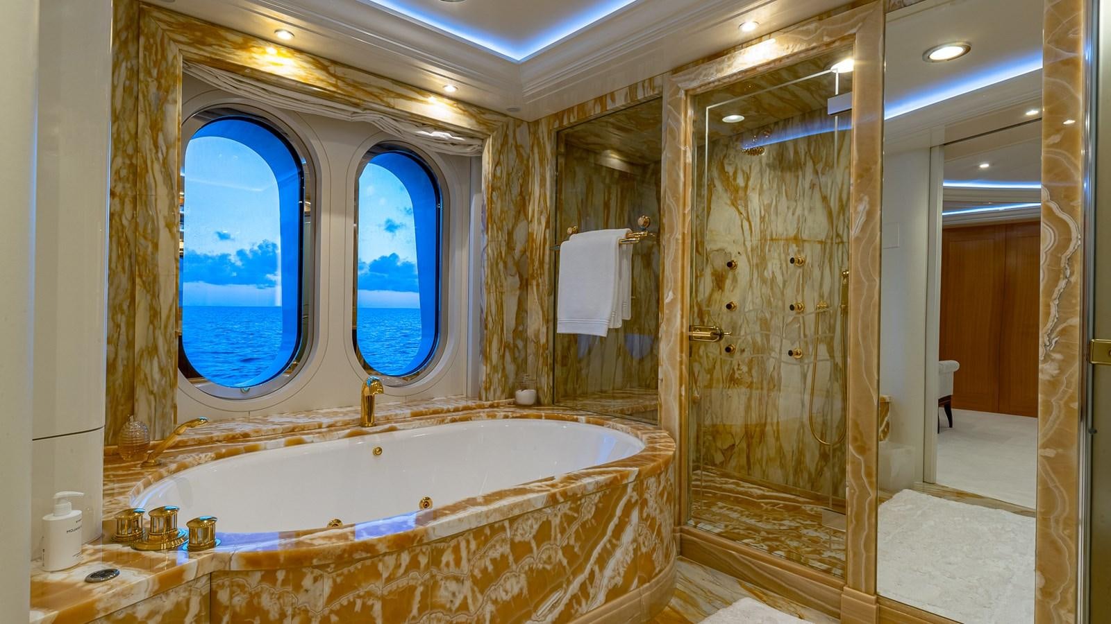 a bathroom with a tub and a shower aboard MARGUERITE Yacht for Charter