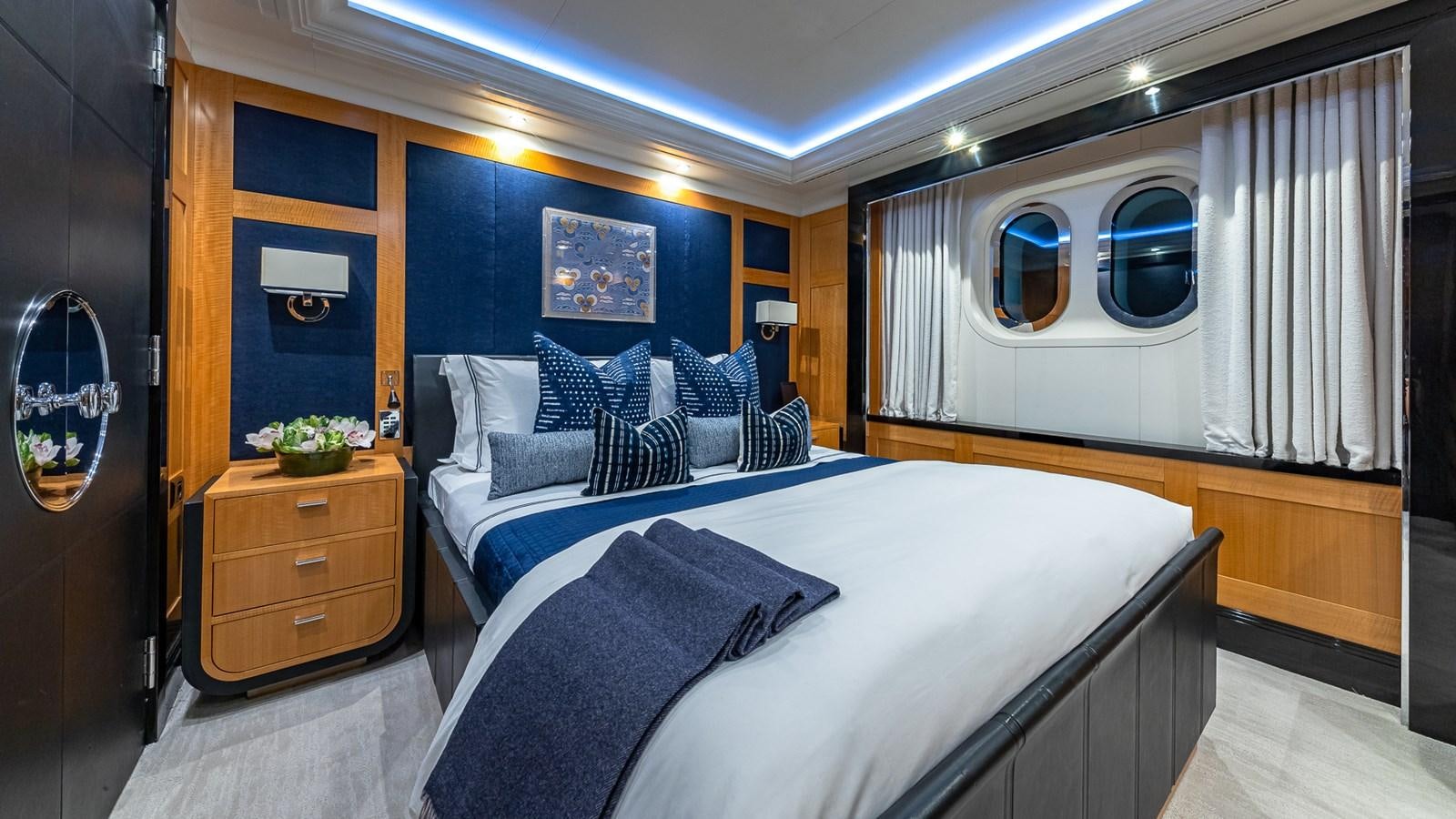 a room with a bed and a mirror aboard MARGUERITE Yacht for Charter