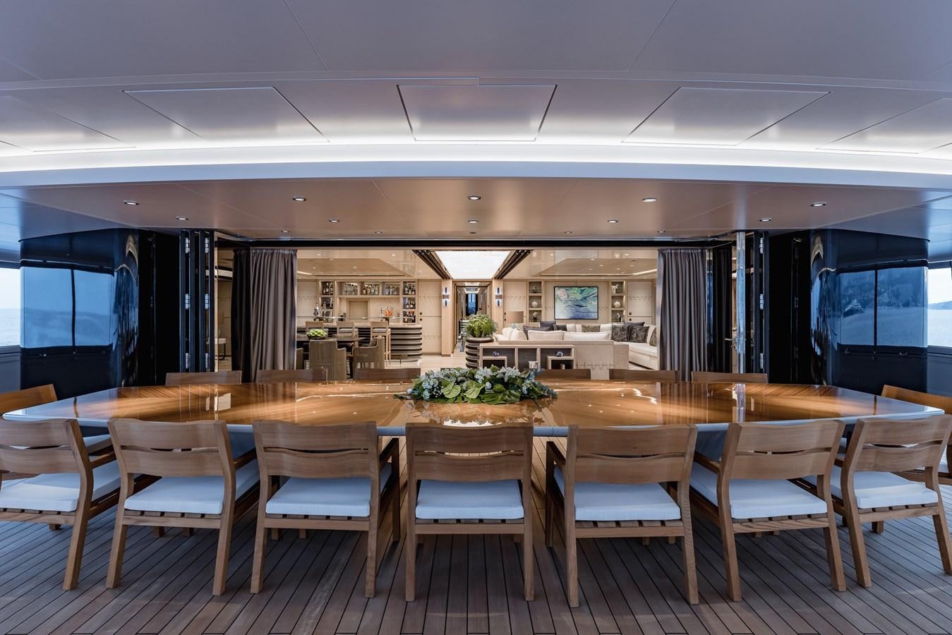 a large room with tables and chairs aboard VICTORIOUS Yacht for Charter
