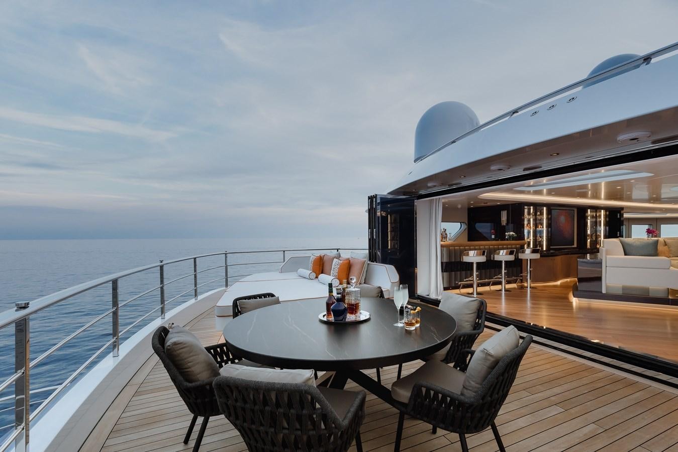 a deck with a table and chairs on it aboard VICTORIOUS Yacht for Charter
