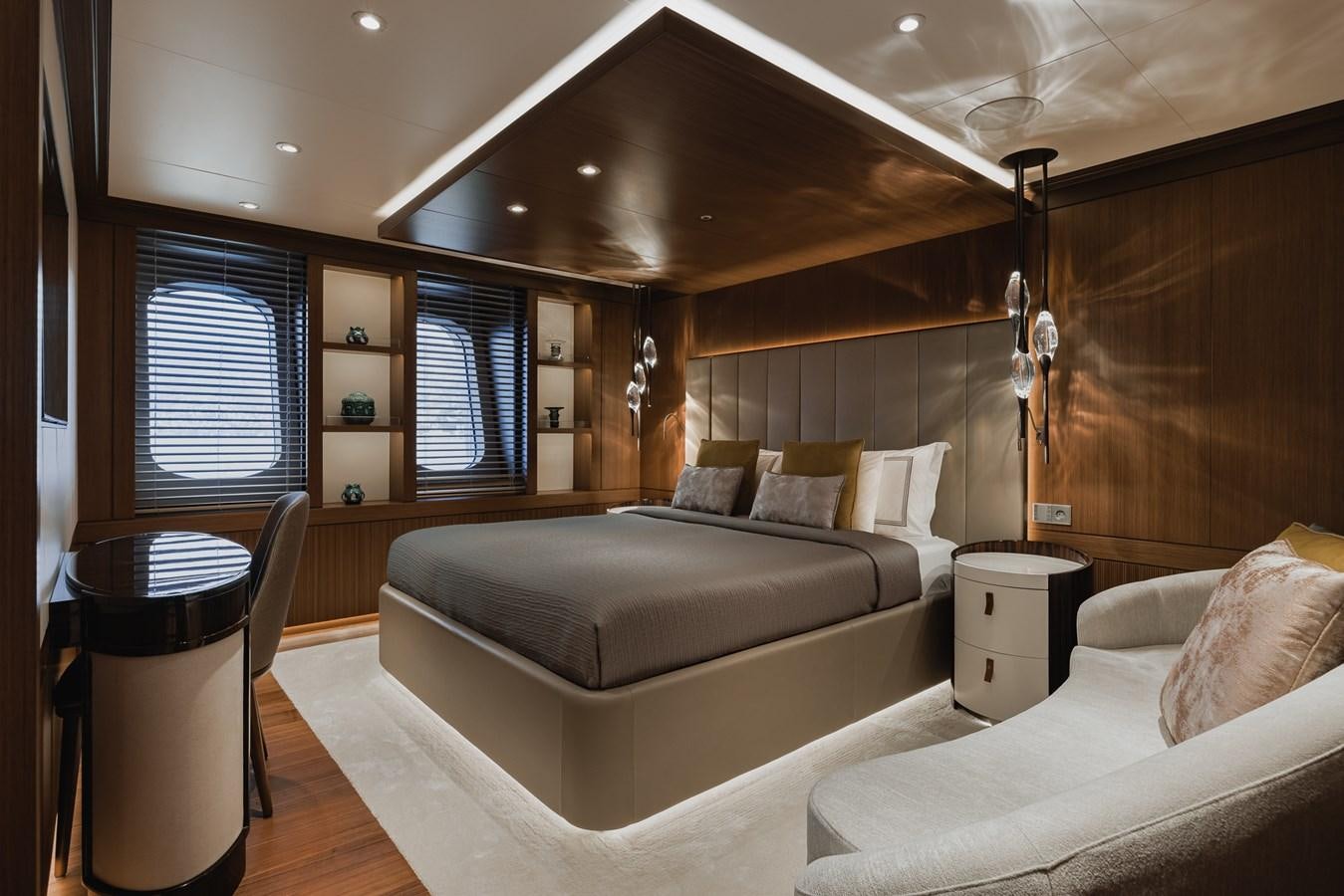 a room with a bed and a chair aboard VICTORIOUS Yacht for Charter