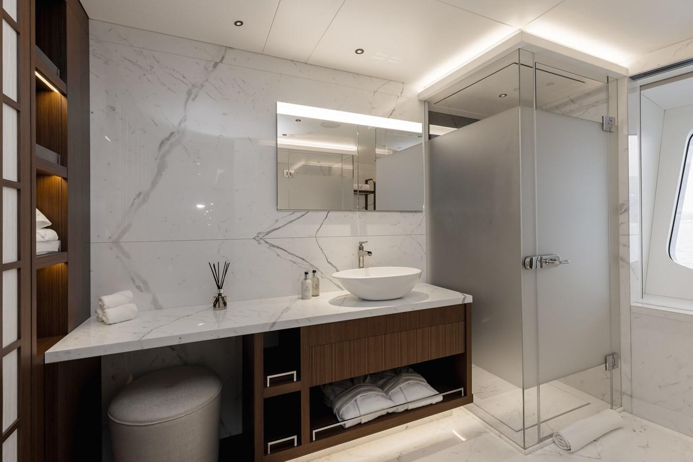a bathroom with a sink and a mirror aboard VICTORIOUS Yacht for Charter