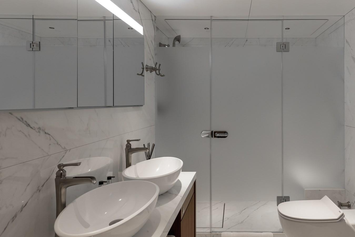 a bathroom with a shower sink and toilet aboard VICTORIOUS Yacht for Charter