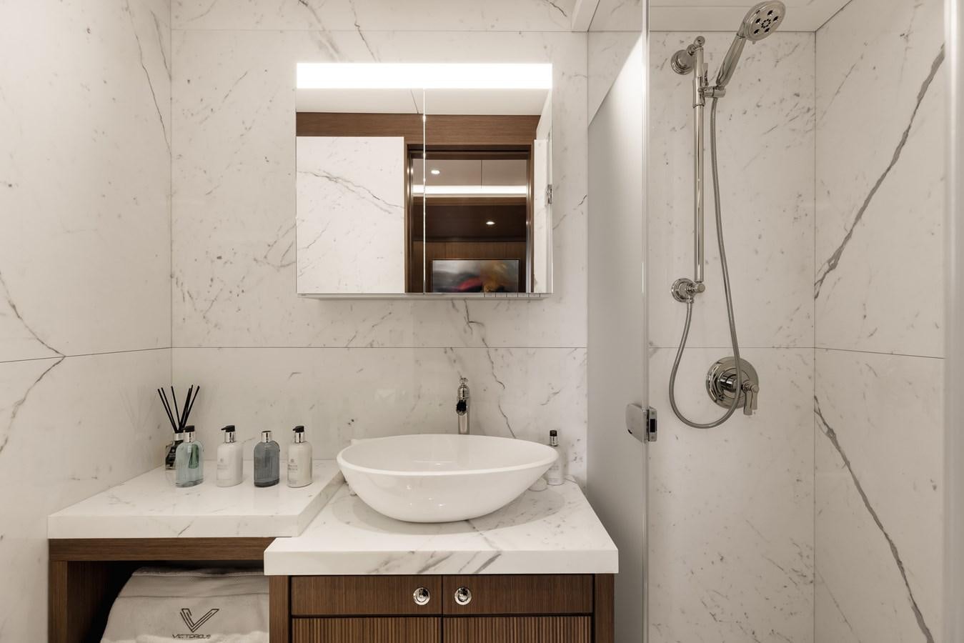 a bathroom with a sink and a mirror aboard VICTORIOUS Yacht for Charter