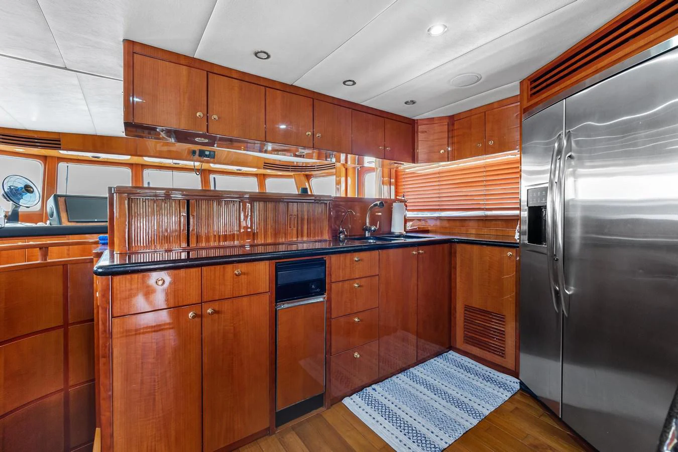 a kitchen with wooden cabinets aboard JEF82110L506 Yacht for Sale