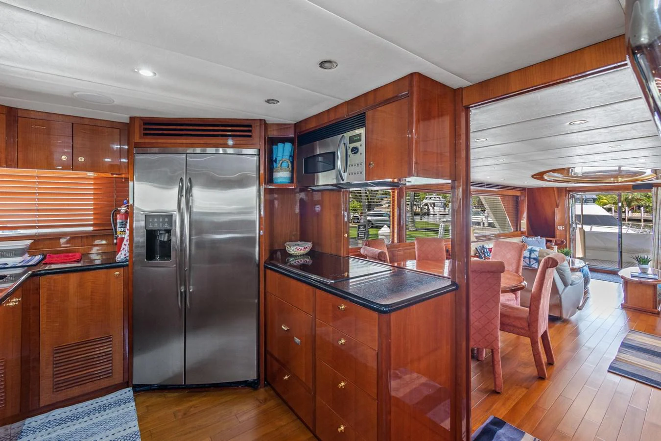 a kitchen with wooden cabinets aboard JEF82110L506 Yacht for Sale