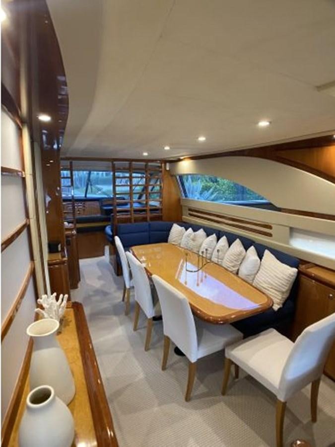 a room with a table and chairs aboard 2005 760 FERRETTI MOTOR YACHT Yacht for Sale