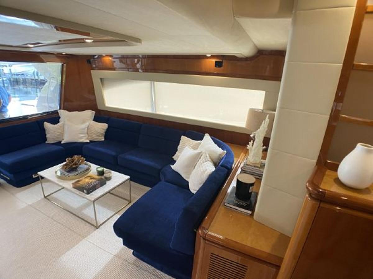 a living room with a blue couch aboard 2005 760 FERRETTI MOTOR YACHT Yacht for Sale