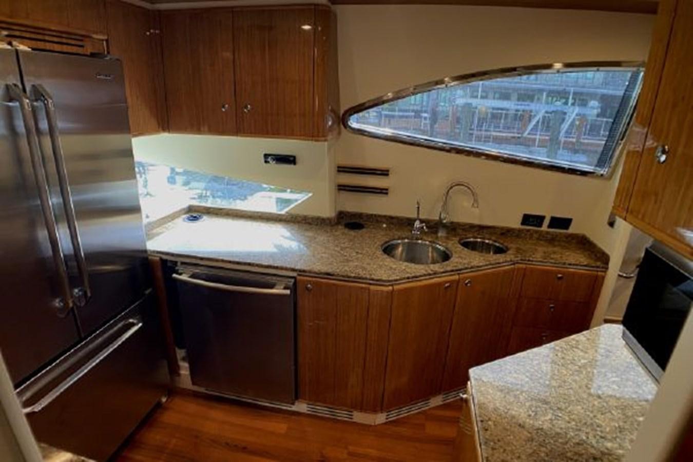 a kitchen with a refrigerator and sink aboard 2005 760 FERRETTI MOTOR YACHT Yacht for Sale