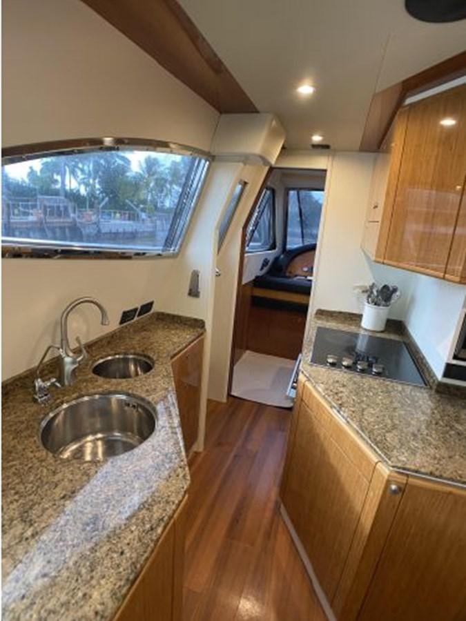 a kitchen with a sink and a window aboard 2005 760 FERRETTI MOTOR YACHT Yacht for Sale
