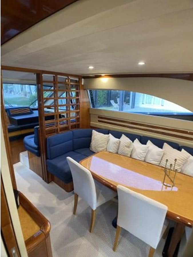 a room with a couch and a table and chairs aboard 2005 760 FERRETTI MOTOR YACHT Yacht for Sale