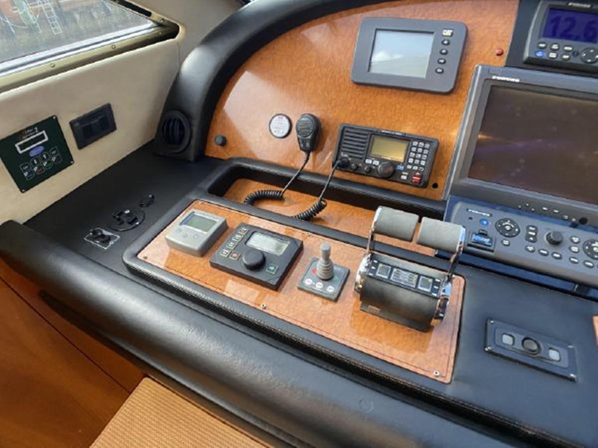 a radio and other electronics on a table aboard 2005 760 FERRETTI MOTOR YACHT Yacht for Sale