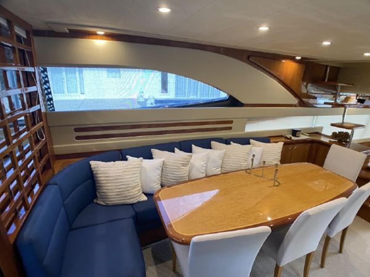 a room with a table and chairs aboard 2005 760 FERRETTI MOTOR YACHT Yacht for Sale
