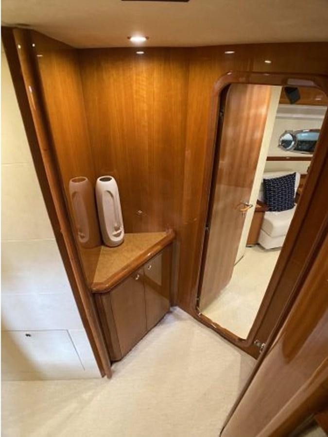a bathroom with a wood cabinet aboard 2005 760 FERRETTI MOTOR YACHT Yacht for Sale
