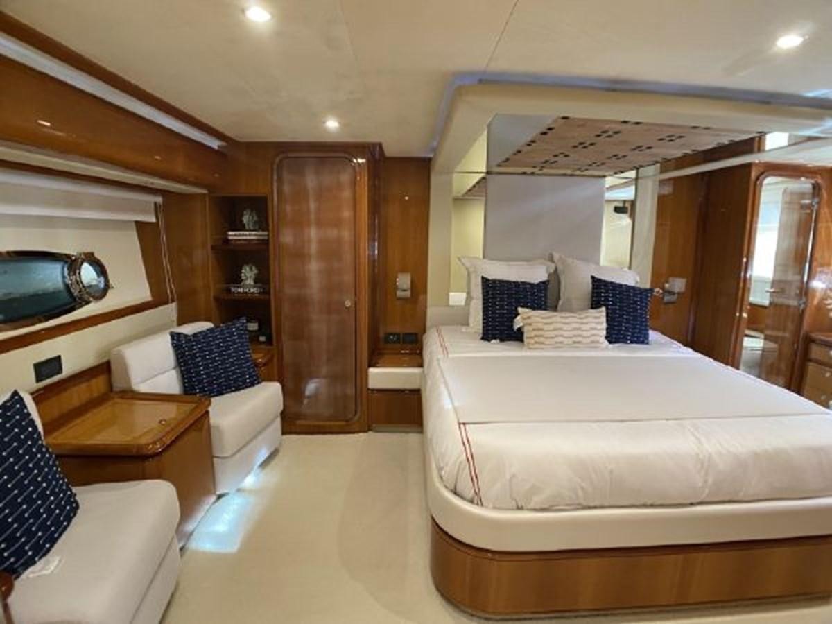a room with a bed and a mirror aboard 2005 760 FERRETTI MOTOR YACHT Yacht for Sale