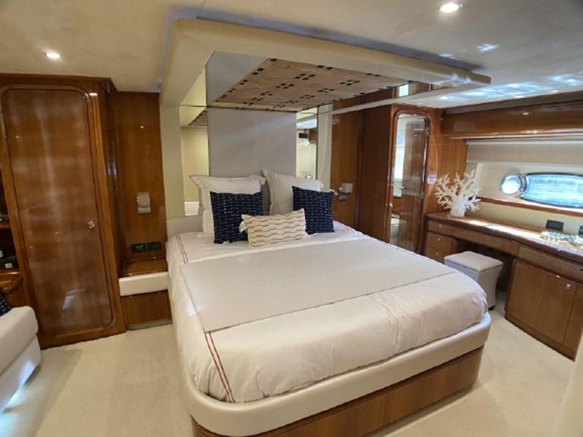 a room with a bed and cabinets aboard 2005 760 FERRETTI MOTOR YACHT Yacht for Sale