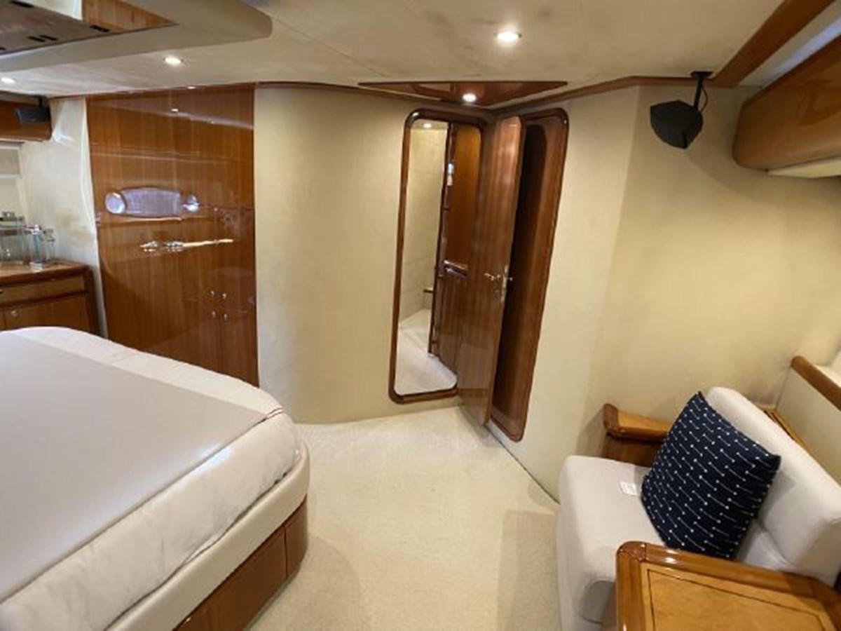 a room with a bed and a closet aboard 2005 760 FERRETTI MOTOR YACHT Yacht for Sale
