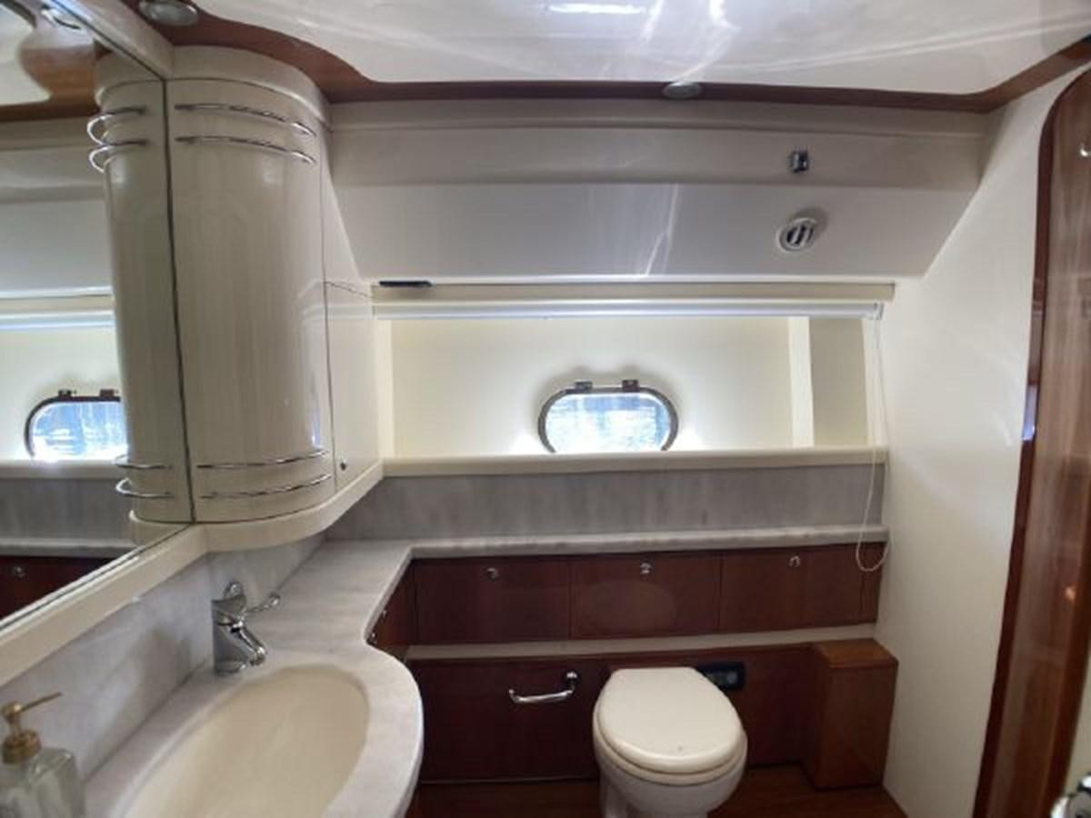a bathroom with a toilet and sink aboard 2005 760 FERRETTI MOTOR YACHT Yacht for Sale