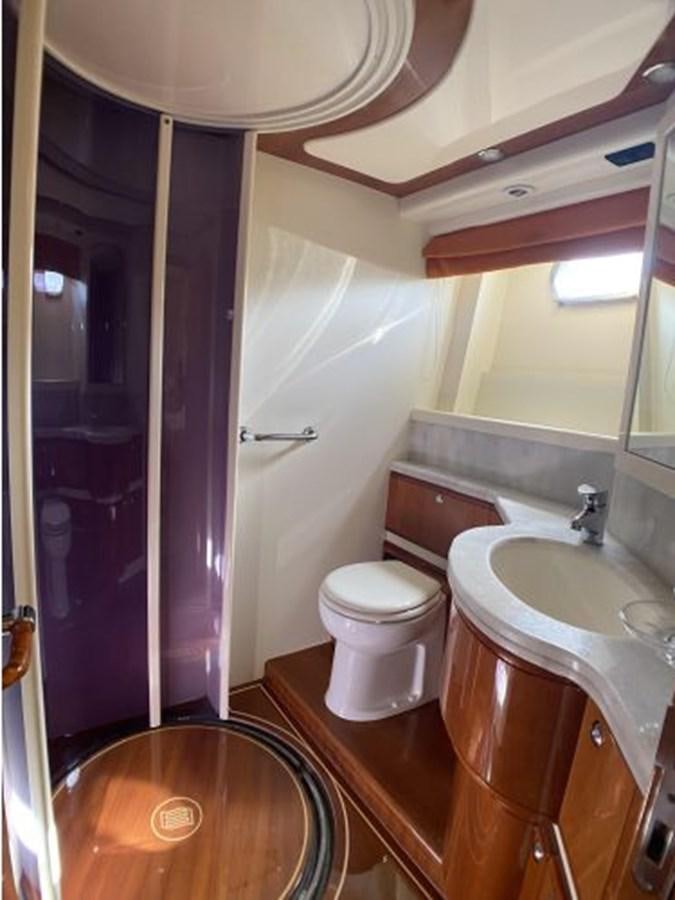 a bathroom with a sink toilet and a shower aboard 2005 760 FERRETTI MOTOR YACHT Yacht for Sale