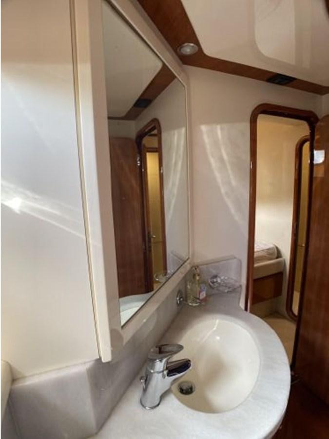 a bathroom with a sink and a mirror aboard 2005 760 FERRETTI MOTOR YACHT Yacht for Sale