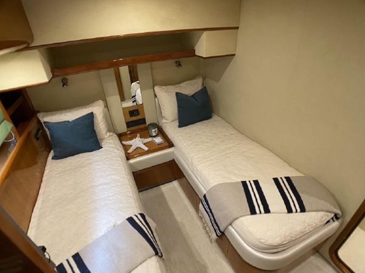 a room with two beds aboard 2005 760 FERRETTI MOTOR YACHT Yacht for Sale