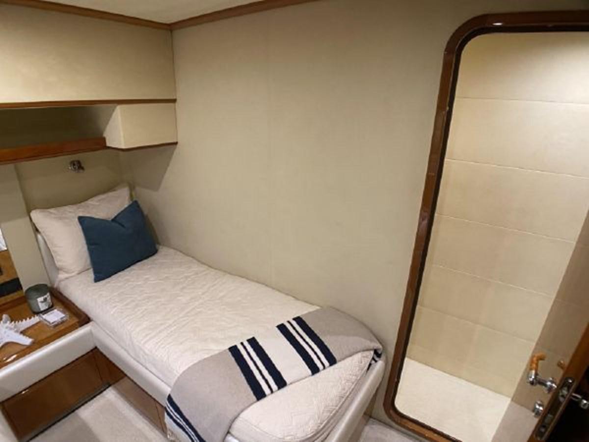 a bed with a white sheet and a mirror aboard 2005 760 FERRETTI MOTOR YACHT Yacht for Sale
