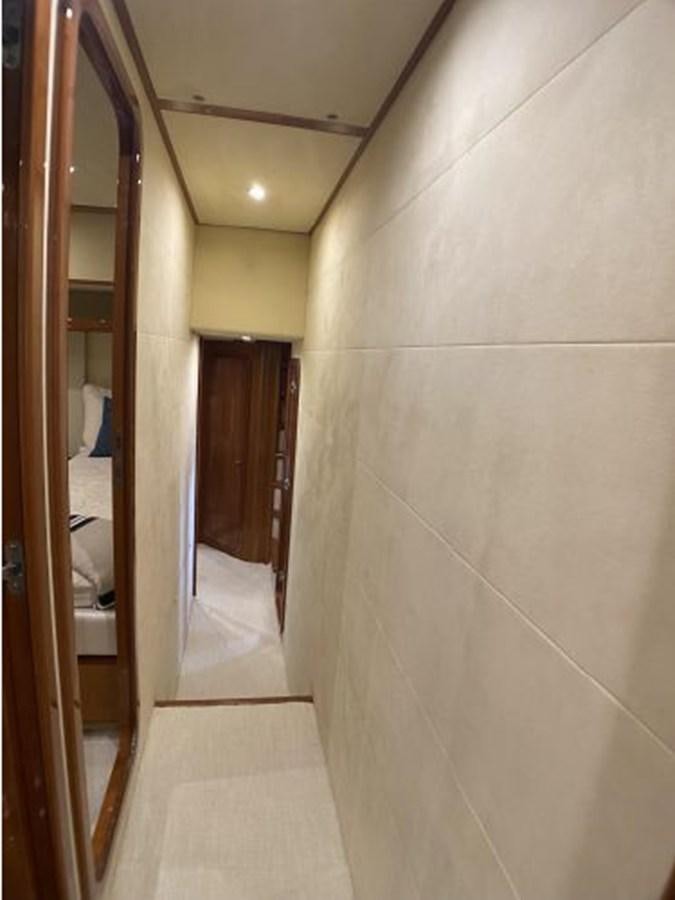 a hallway with a door and a mirror aboard 2005 760 FERRETTI MOTOR YACHT Yacht for Sale