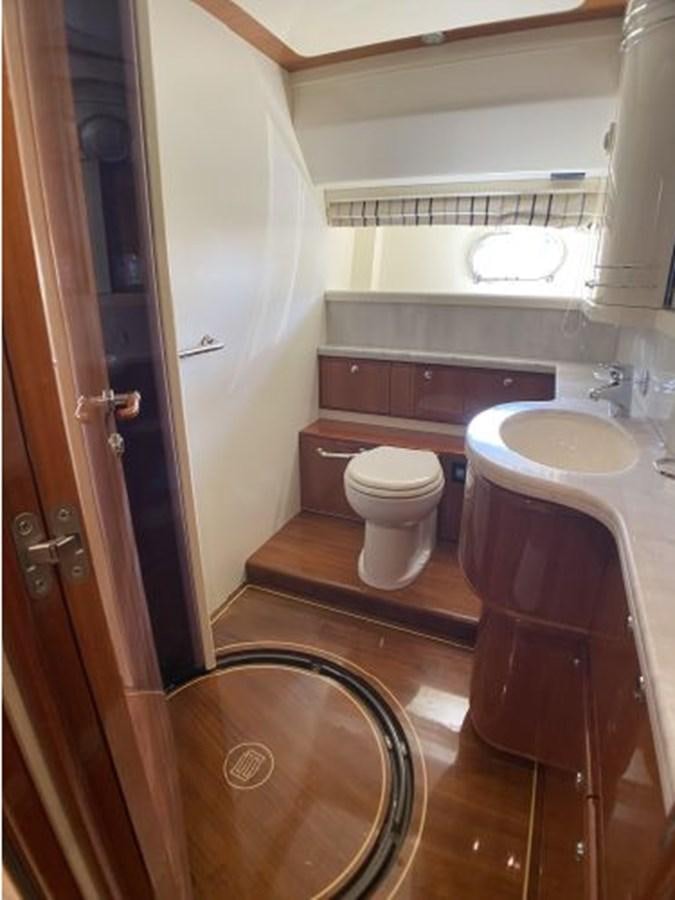 a bathroom with a toilet and sink aboard 2005 760 FERRETTI MOTOR YACHT Yacht for Sale