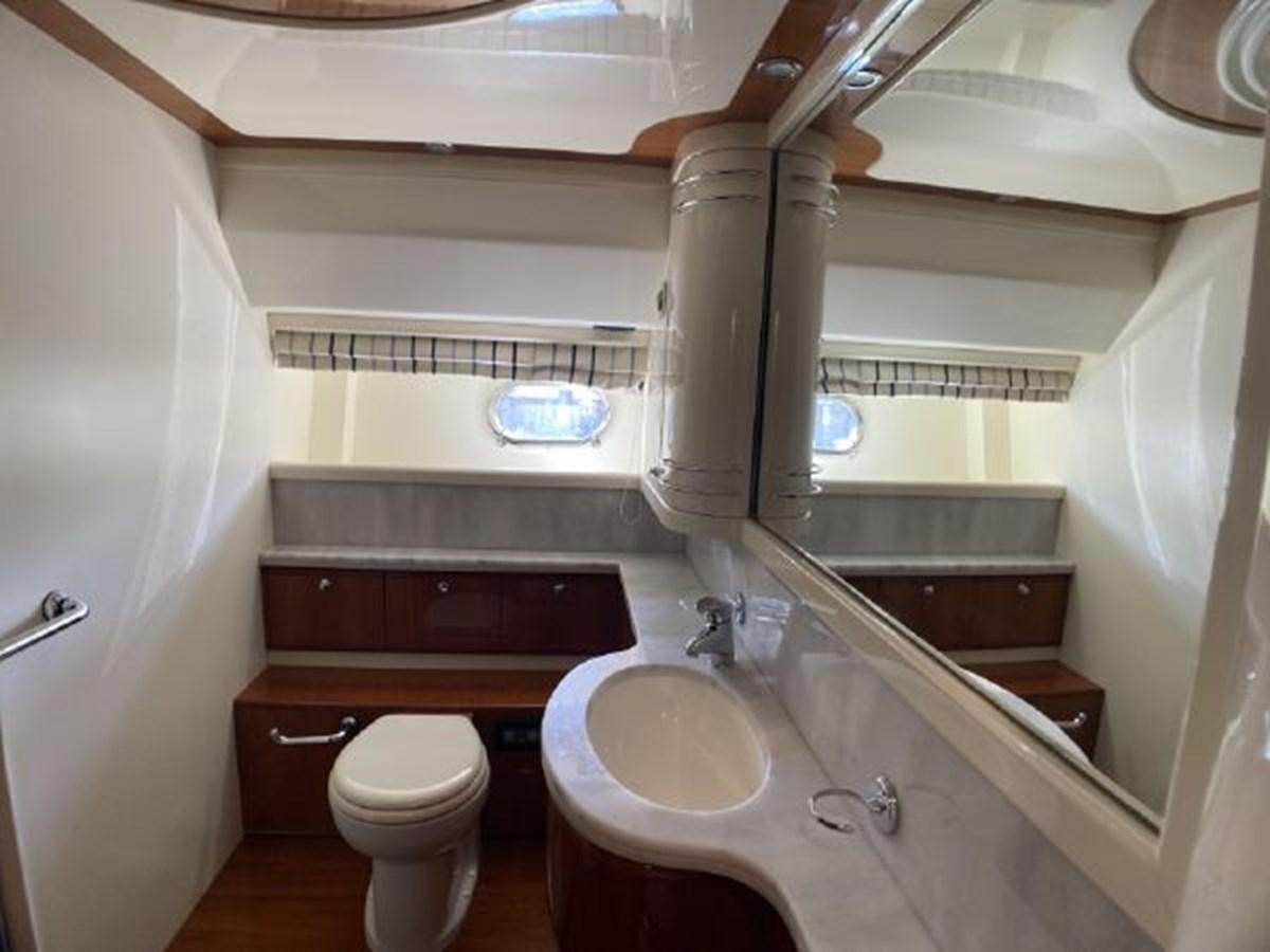 a bathroom with a toilet sink and bathtub aboard 2005 760 FERRETTI MOTOR YACHT Yacht for Sale