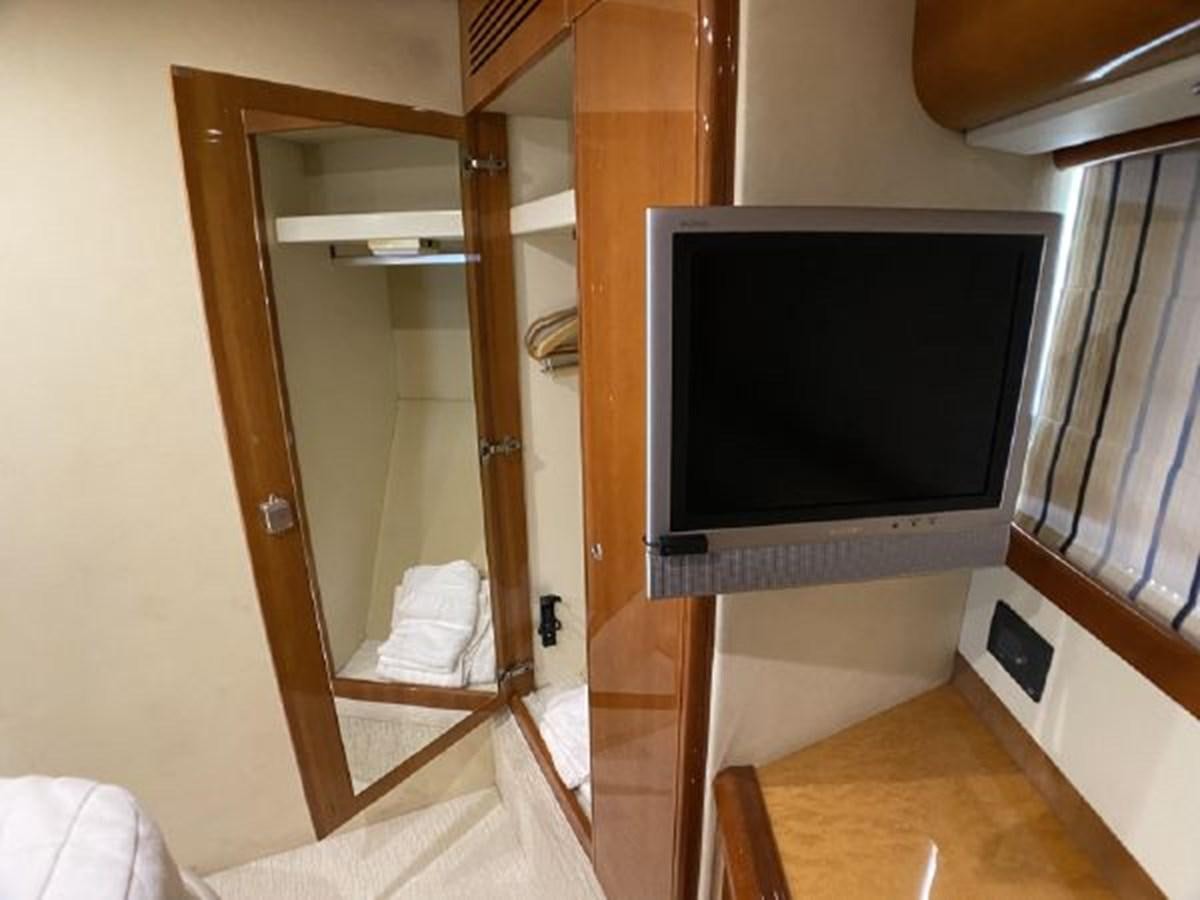 a tv on a stand in a room aboard 2005 760 FERRETTI MOTOR YACHT Yacht for Sale
