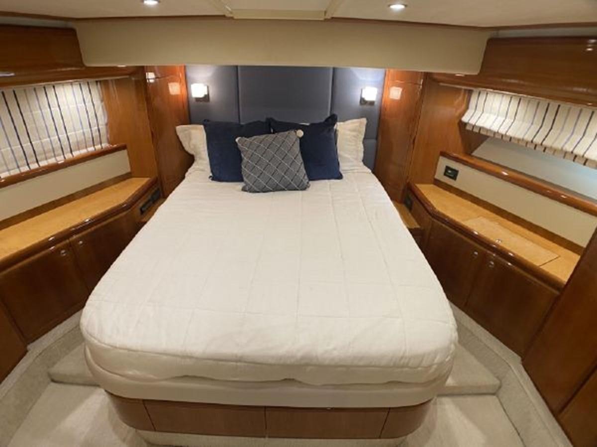 a bed with blue pillows aboard 2005 760 FERRETTI MOTOR YACHT Yacht for Sale