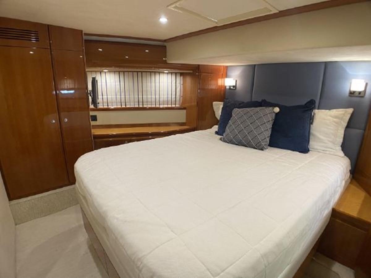 a bed with blue and white pillows aboard 2005 760 FERRETTI MOTOR YACHT Yacht for Sale