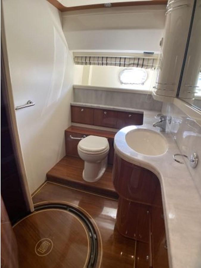 a bathroom with a sink toilet and a bathtub aboard 2005 760 FERRETTI MOTOR YACHT Yacht for Sale