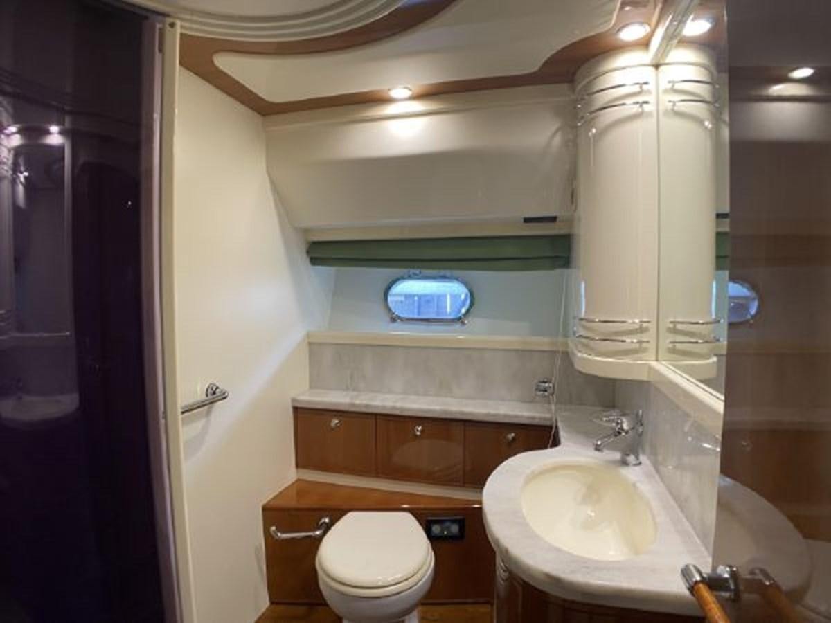 a bathroom with a toilet and sink aboard 2005 760 FERRETTI MOTOR YACHT Yacht for Sale