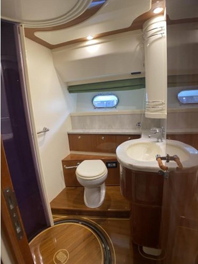 a bathroom with a sink and toilet aboard 2005 760 FERRETTI MOTOR YACHT Yacht for Sale