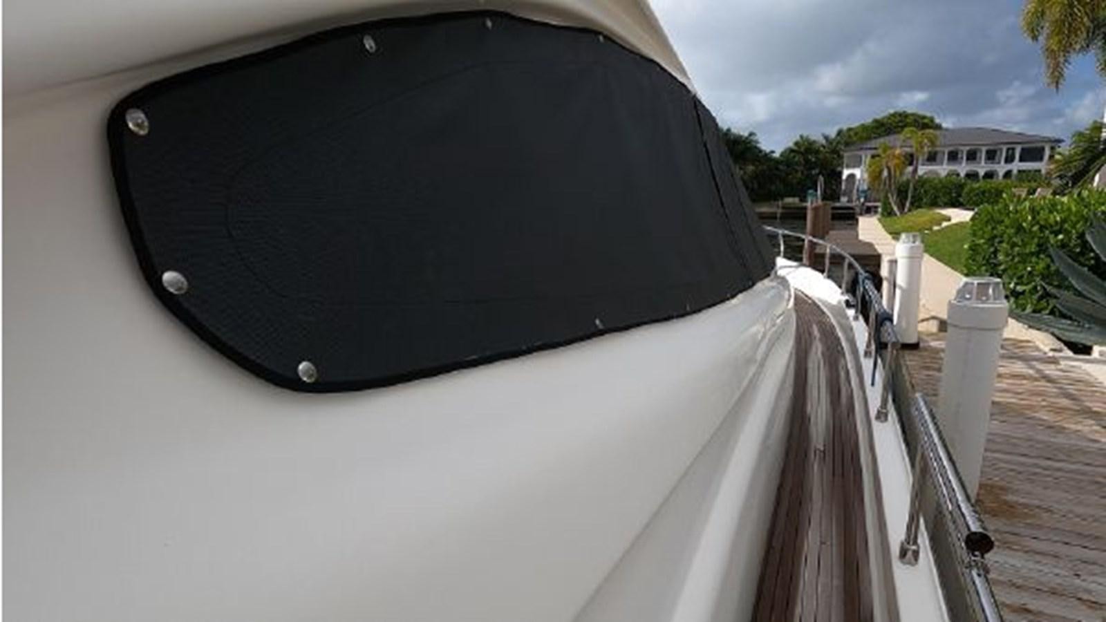 a black umbrella on a balcony aboard 2005 760 FERRETTI MOTOR YACHT Yacht for Sale