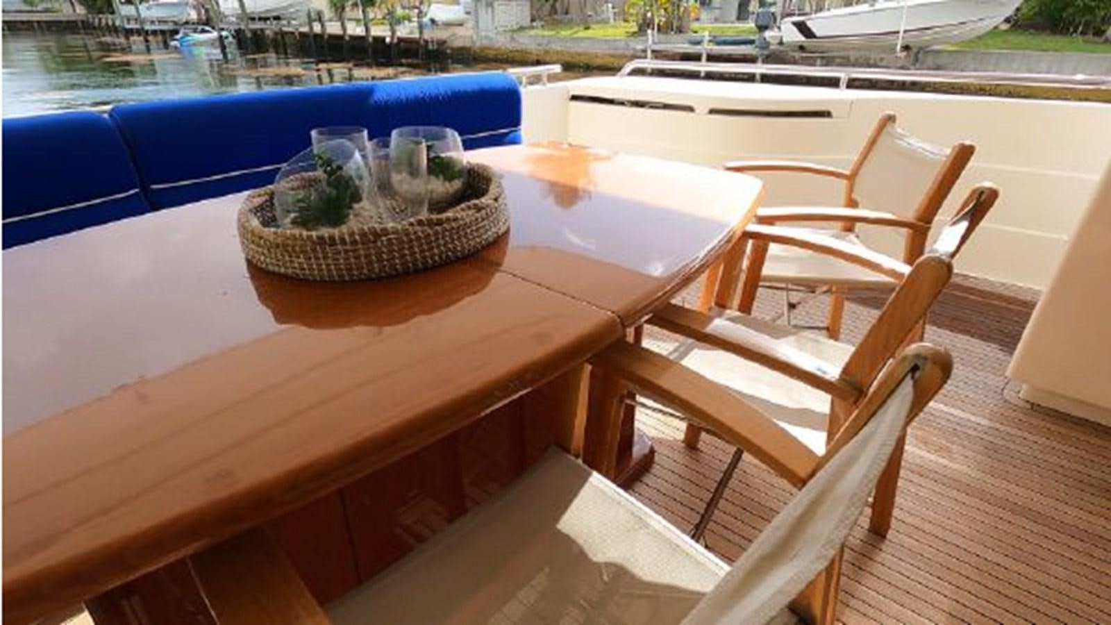 a table with a basket and a plant on it aboard 2005 760 FERRETTI MOTOR YACHT Yacht for Sale