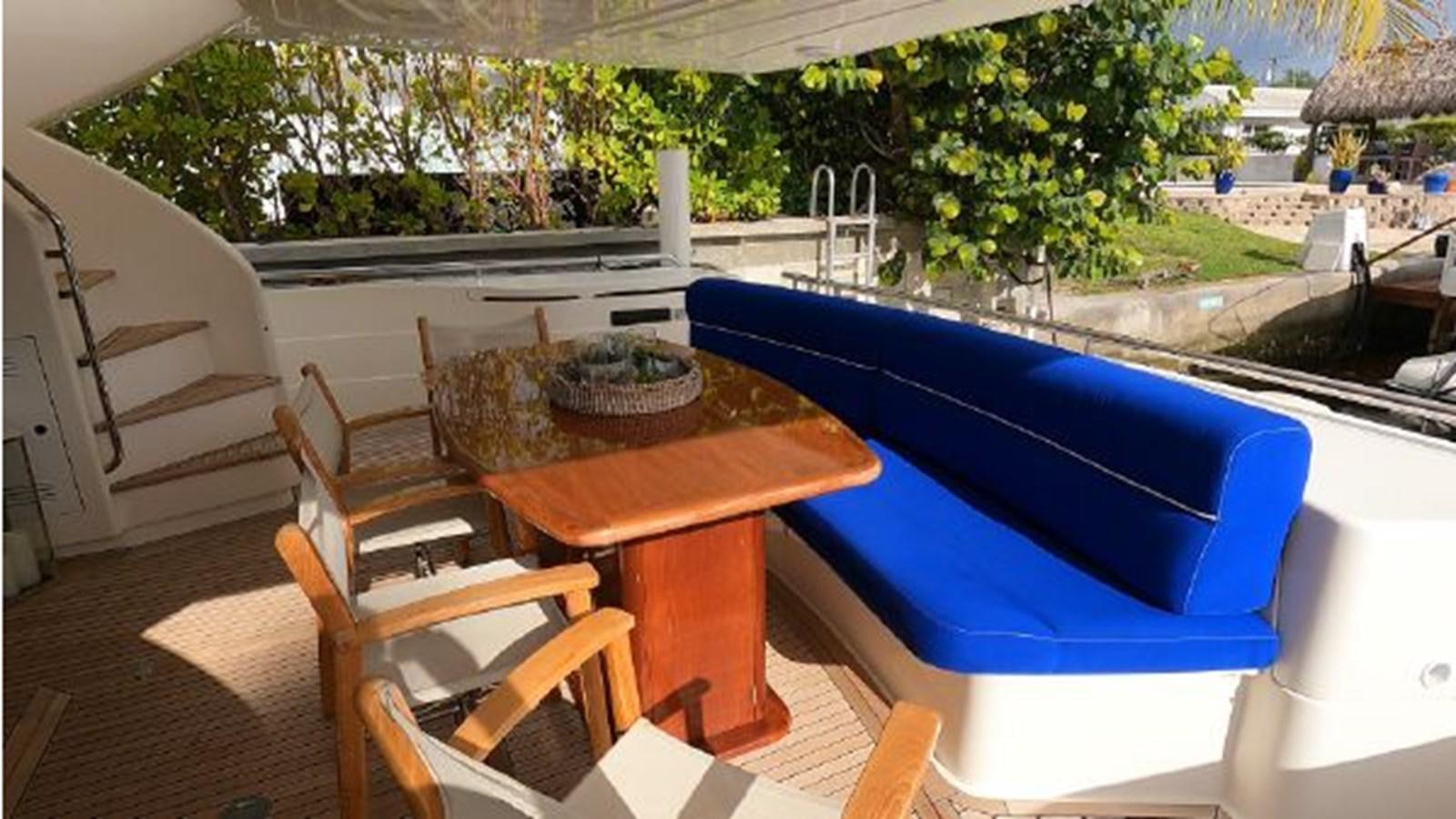 a table and chairs on a deck aboard 2005 760 FERRETTI MOTOR YACHT Yacht for Sale