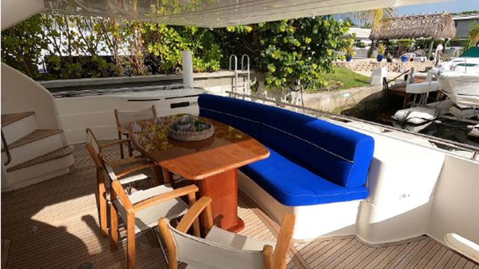 a table and chairs on a deck aboard 2005 760 FERRETTI MOTOR YACHT Yacht for Sale