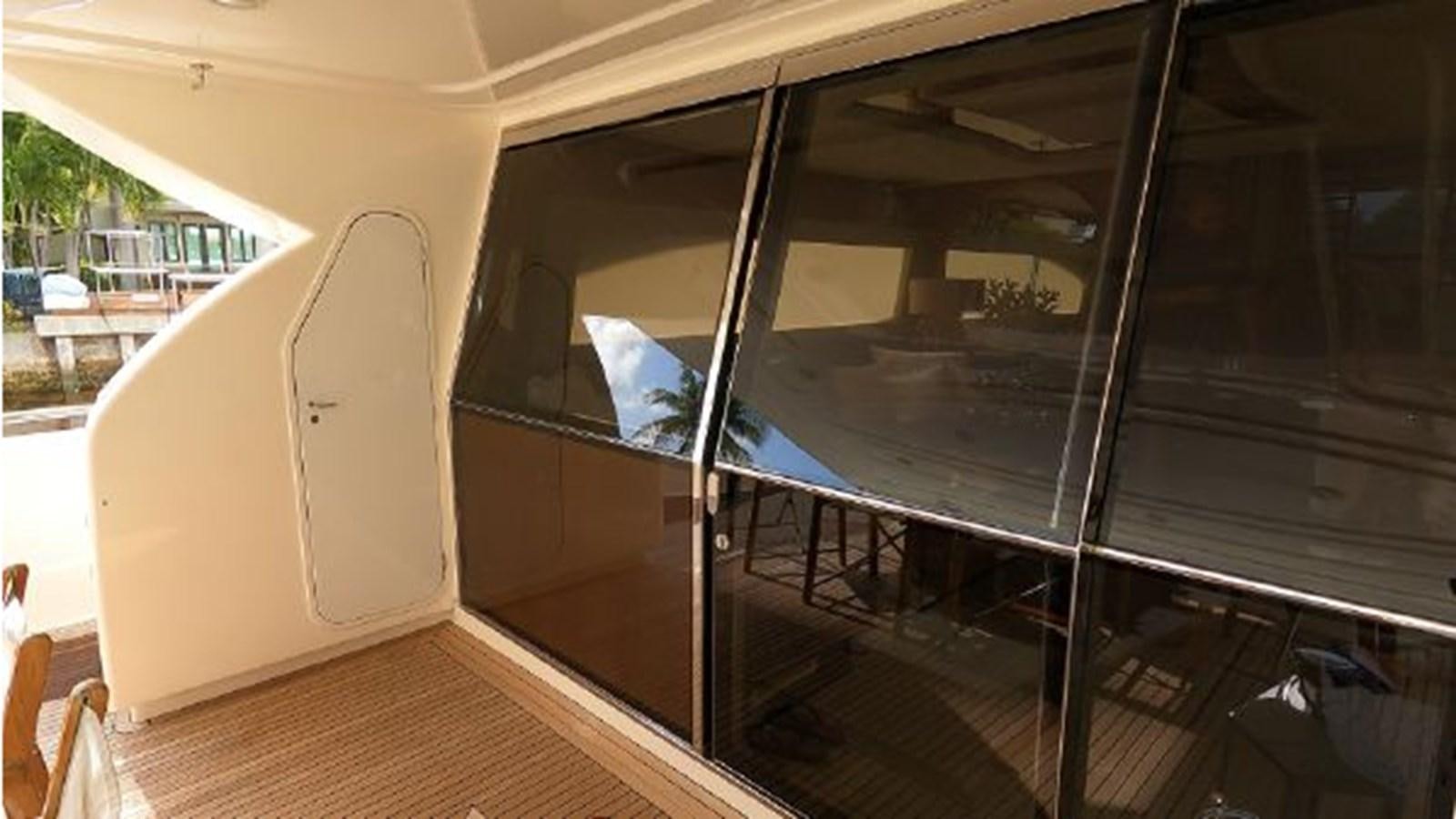 a room with a sliding door aboard 2005 760 FERRETTI MOTOR YACHT Yacht for Sale