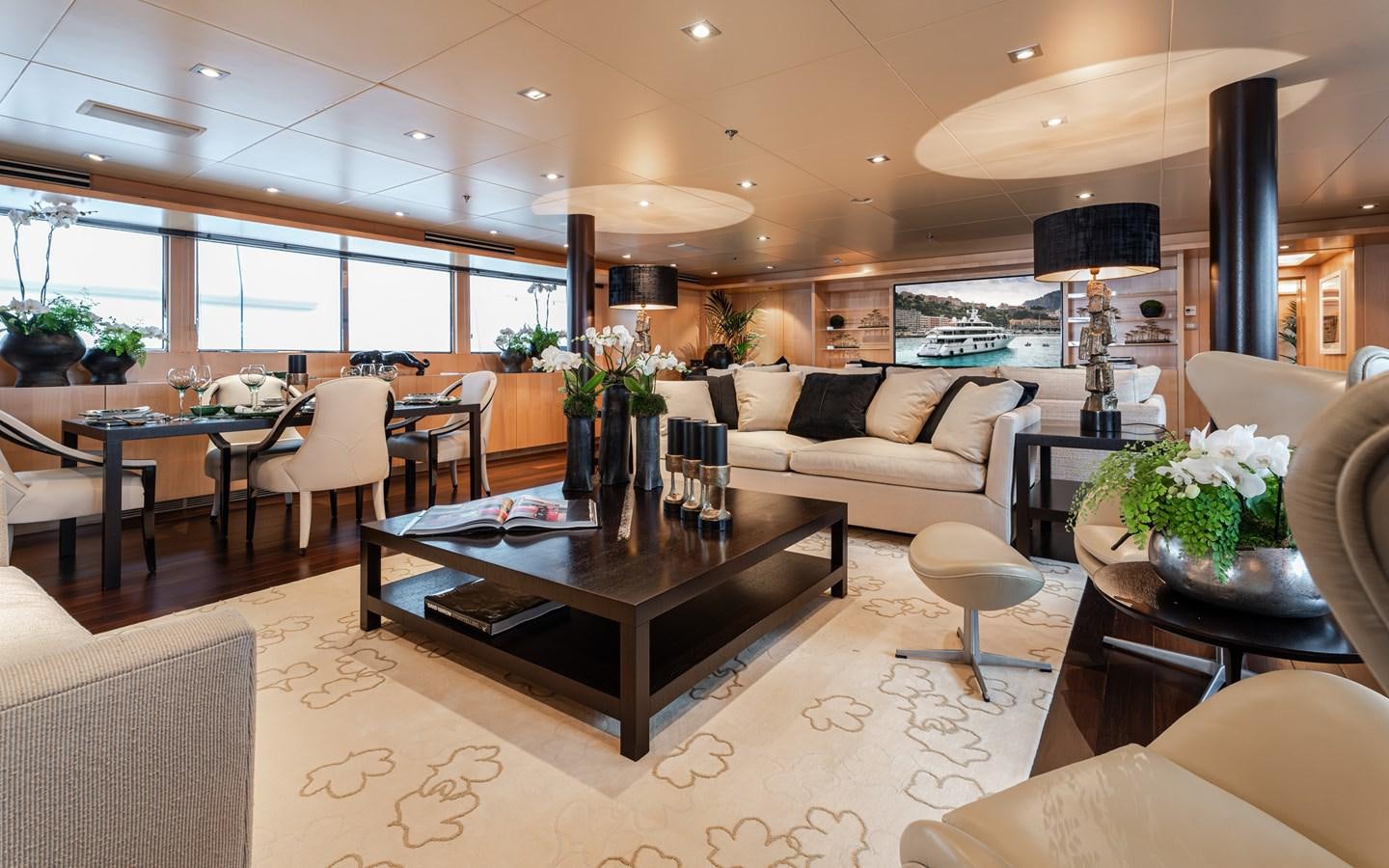 a living room with a table and chairs aboard MONEIKOS Yacht for Sale