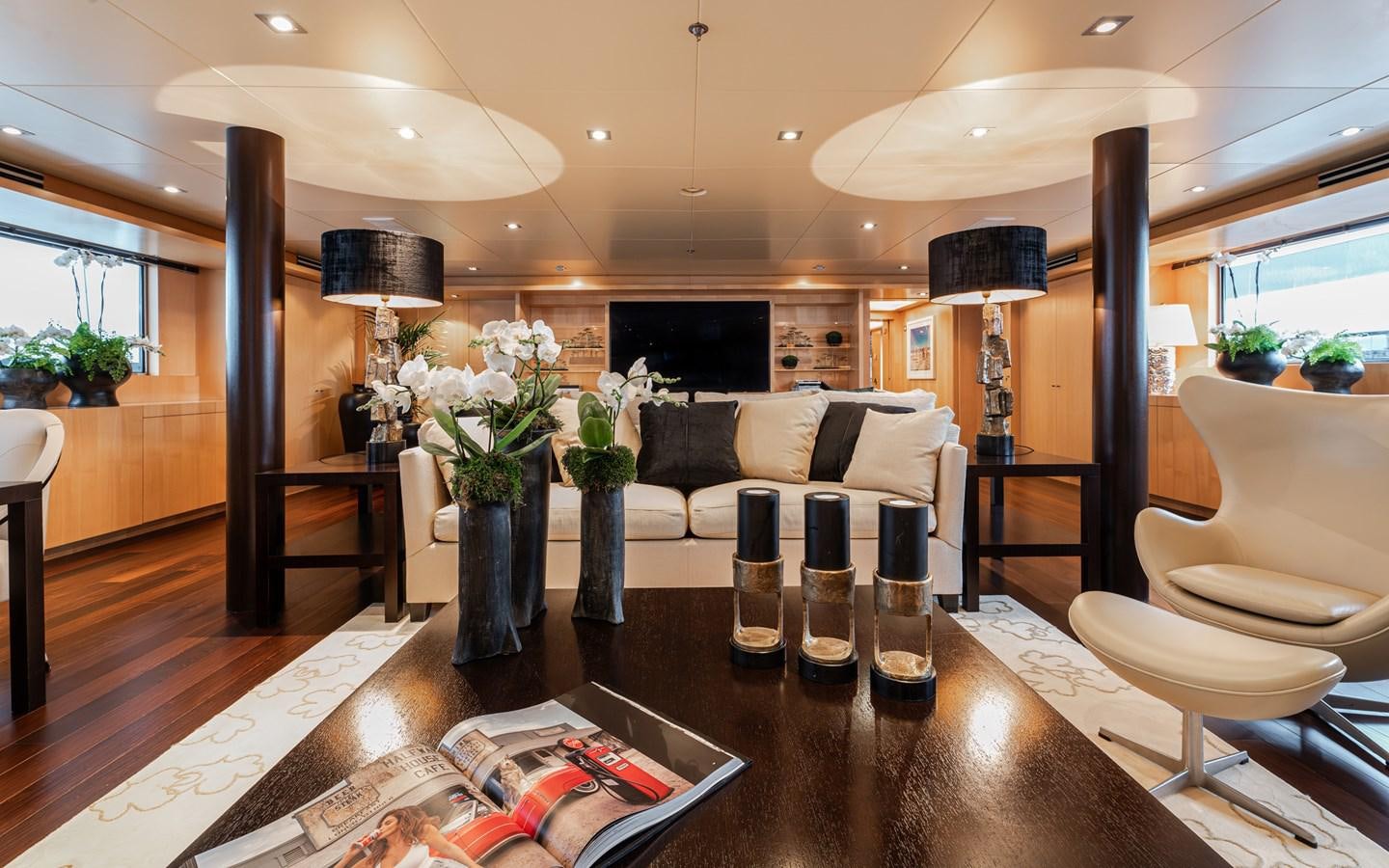 a living room with a large table and chairs aboard MONEIKOS Yacht for Sale