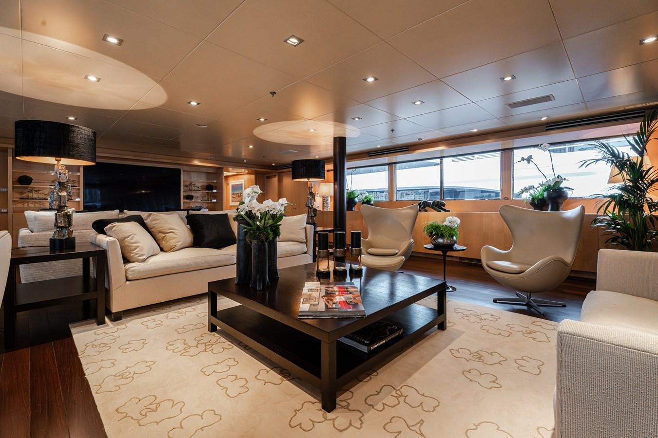 a living room with a table and chairs aboard MONEIKOS Yacht for Sale